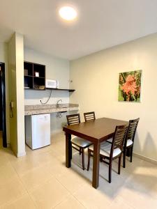 a kitchen and dining room with a table and chairs at Hotel Saint Paul in Manaus