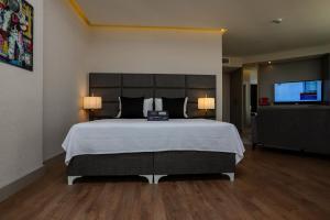 a bedroom with a large bed and a flat screen tv at Brand Business Hotel in Çorlu