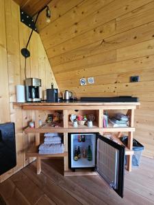 a wooden cabin with a small refrigerator in it at LOGIS LAS CROZAS La Cocotte in Vernines
