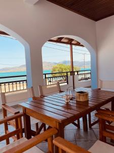 a dining room with a table and views of the ocean at GIALOS APARTMENT in Elafonisos