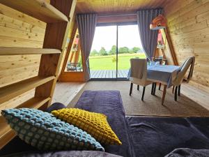 a room with a couch and a table and a dining room at LOGIS LAS CROZAS La Cocotte in Vernines