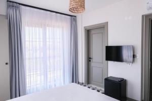 a bedroom with a bed and a large window at Arcadia Butik Otel in Canakkale