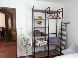 a black shelving unit with a fan in a room at Barcena in Durango