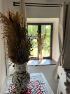 a vase with flowers in it sitting on a table at A Házikó - Cottage in Vonyarcvashegy