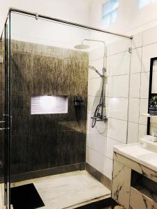 a bathroom with a shower and a sink at Kulem Gempol in Bandung