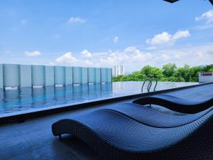 a swimming pool on the roof of a building at The Majestic Ipoh 5 PAX Blissful Ten Floor FULLY AIR-CON Suite in Ipoh