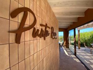 a sign on the side of a building at Punta Rasa Formentera Apartments in Cala Saona