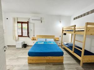 a bedroom with two bunk beds and a window at Thalassa Casa Vacanza in Anzio