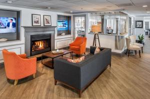 a living room with a couch and a fireplace at The Newport Harbor Hotel & Marina in Newport