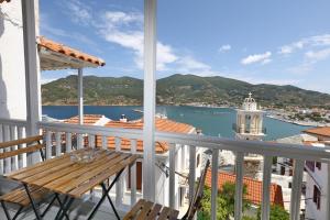 balcón con mesa y vistas al agua en House of town, en Skopelos Town