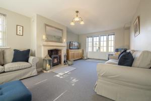 a living room with two couches and a fireplace at Saxon House 7 in Harome