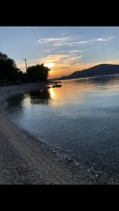 a sunset over a body of water with a beach at Seaesta holiday- Modern studio in Okrug Gornji