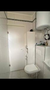 a white bathroom with a toilet and a sink at Seaesta holiday- Modern studio in Okrug Gornji
