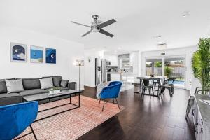a living room with a couch and a table at Spacious 5 Bedrooms with Large Pool, 12 minutes to the Ocean in Fort Lauderdale