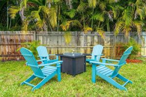 three blue chairs and a table in a yard at Spacious 5 Bedrooms with Large Pool, 12 minutes to the Ocean in Fort Lauderdale