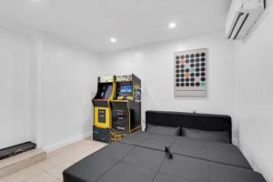 a bedroom with a black bed in a white room at Spacious 5 Bedrooms with Large Pool, 12 minutes to the Ocean in Fort Lauderdale