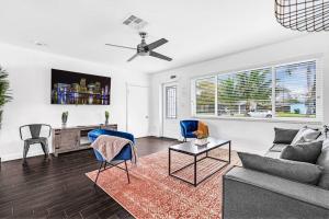 a living room with a couch and chairs and a table at Spacious 5 Bedrooms with Large Pool, 12 minutes to the Ocean in Fort Lauderdale