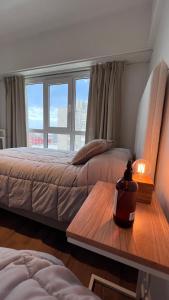 a bedroom with two beds and a table with a lamp at Administración Almafuerte in Mar del Plata