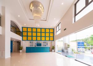 a large lobby with yellow and blue accents at Minh Chau Pearl Hotel & Spa - Quan Lan Island in Quang Ninh