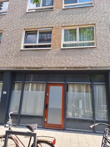 a building with a door and a bike parked outside at Beautiful studio 14F in chic neighborhood in center in Rotterdam