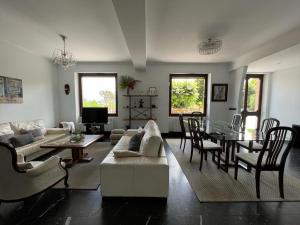 sala de estar con sofá blanco y mesa en Casa señorial a 5 minutos del centro, en San Sebastián