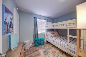 a bedroom with a bunk bed and blue walls at Sea Horse 112 by Vacation Homes Collection in Gulf Shores