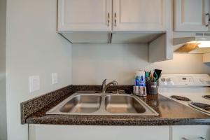 a kitchen with a sink and a counter top at Sea Horse 112 by Vacation Homes Collection in Gulf Shores +25 photos