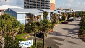 a street with a row of houses and palm trees at Sea Horse 112 by Vacation Homes Collection in Gulf Shores