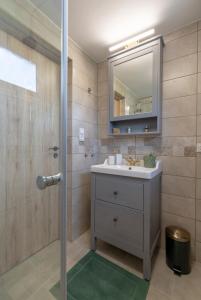 een badkamer met een wastafel en een spiegel bij Jódi-Hegy Resort Siófok in Siófok