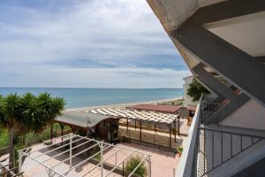 a view of the beach from the balcony of a house at SEAFRONT SUITE 5 Stars - Comfortable Apartment in Marina di Strongoli +10 photos