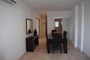 a dining room with a table and black chairs at Little Princess in Luanda