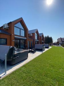 a house with a lawn in front of it at Apartamenty MarMar in Sławoszynko