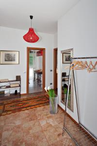 a living room with a mirror and a red light at D&D House in Bergamo