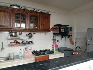 a kitchen with wooden cabinets and a stove top oven at KHAOULA in Rabat