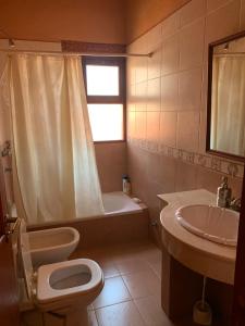 a bathroom with a toilet and a sink at La casa de Mamina in Tilcara