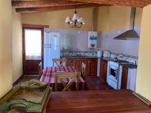 a kitchen with a table and a kitchen with a stove at La casa de Mamina in Tilcara