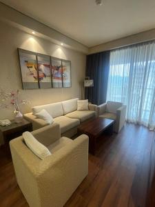 a living room with a couch and a table at Dreamland Oasis Chakvi apartment 1406 in Chakvi