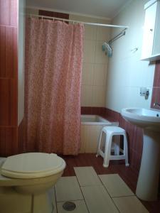 a bathroom with a toilet and a sink and a stool at Hotel Pyrgos in Kounoupidhianá