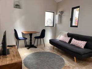 a living room with a couch and a table at Petite maison cosy in Six-Fours-les-Plages