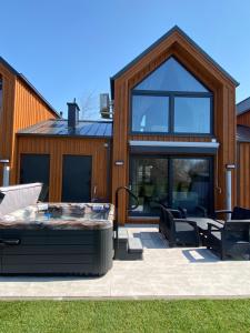a house with a hot tub in the yard at Apartamenty MarMar in Sławoszynko