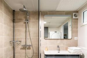 a bathroom with a shower with a sink and a mirror at Ostal périgourdine - Comme à la maison in Périgueux