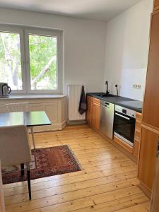 a kitchen with a table and a stove top oven at Mathilde Zimmervermietung in Lengede