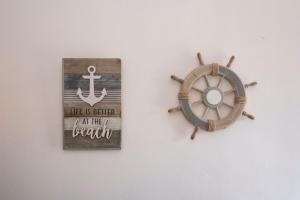 an image of an anchor and a sign on a wall at Casa Claire in San Vito lo Capo +13 photos