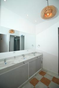 a bathroom with three sinks and a large mirror at Hostal Casa Torres Centro Historico - Adults Only in Cartagena de Indias