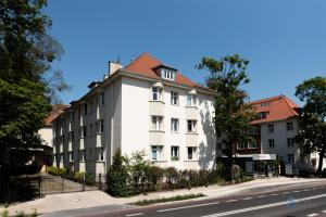 a white building on the side of a street at Aviator Superior by 3City Rentals in Sopot