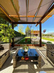 an outdoor patio with a glass table and a table at Casa Rurale Faraone in Teggiano