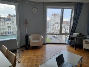 a living room with a laptop computer on a table at Sunny in Antwerp