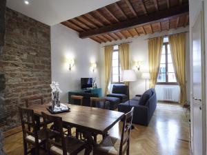 sala de estar con mesa, sillas y sofá en Yome - Your Home in Florence, en Florencia