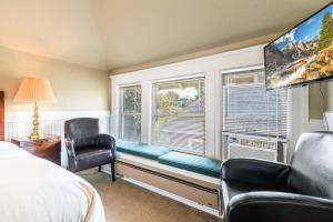 a bedroom with a window seat with a couch and a chair at Seattle Gaslight Inn in Seattle