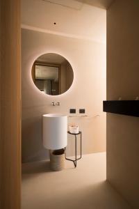 W łazience znajduje się biała umywalka i lustro. w obiekcie Calitro Mare w mieście Torre Ovo